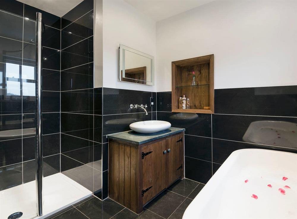 Contemporary en-suite bathroom with free-standing bath at Gowan Bank Farm Cottage in Ings, near Windermere, Cumbria