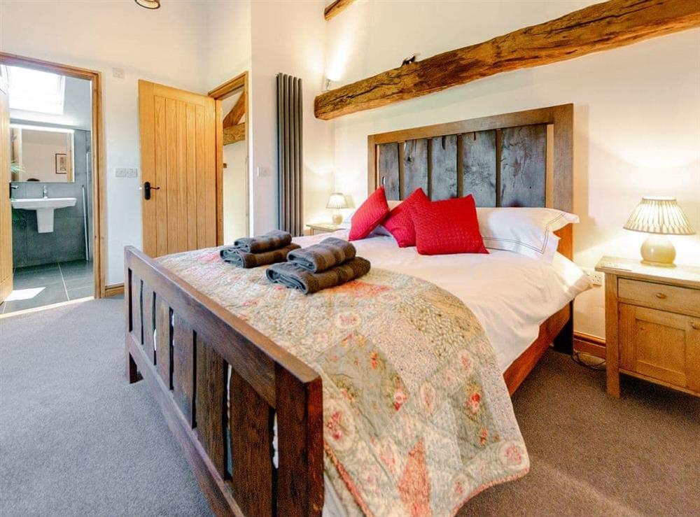 Romantic beamed bedroom at Stone Barn Cottage, 