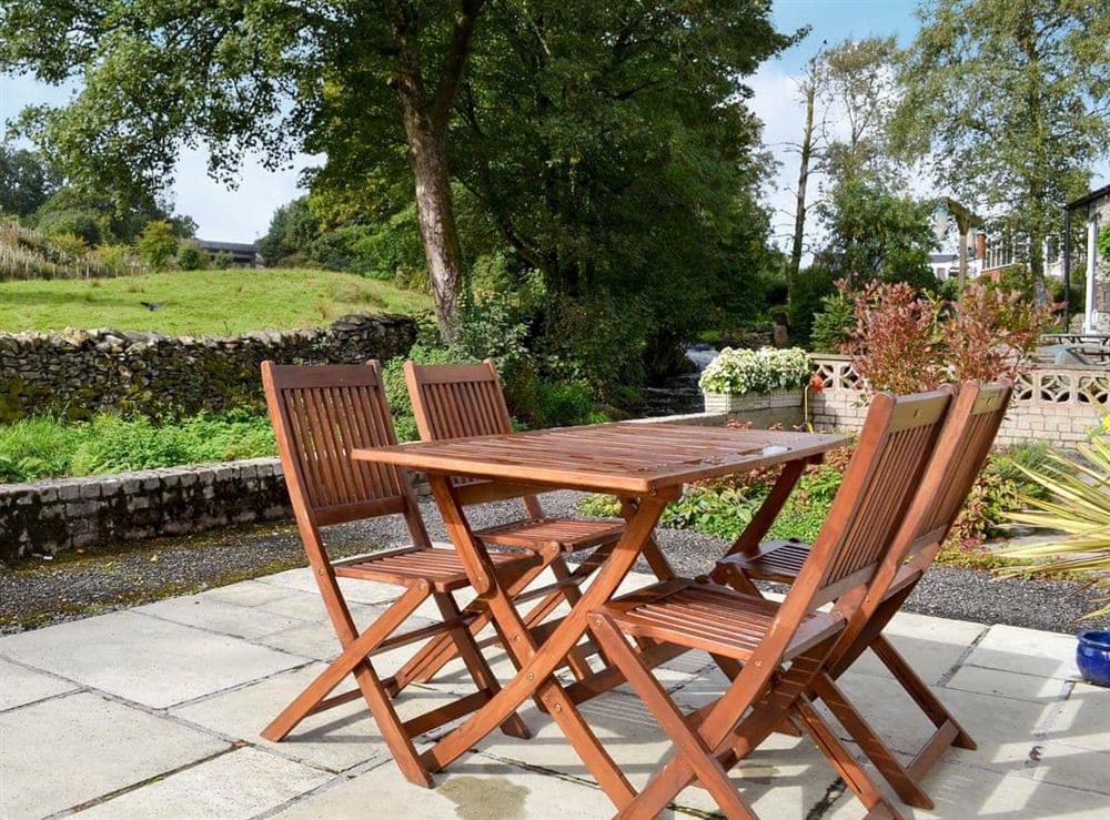Terrace with firniture overlooking the River Gowan at Gowan in Staveley, near Kendal, Cumbria