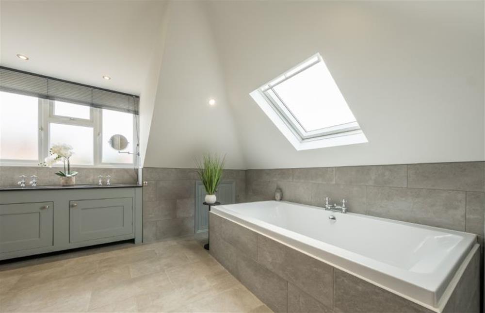 First floor: Large double ended bath with views of the sky overhead at Grace Cottage, Heacham near Kings Lynn