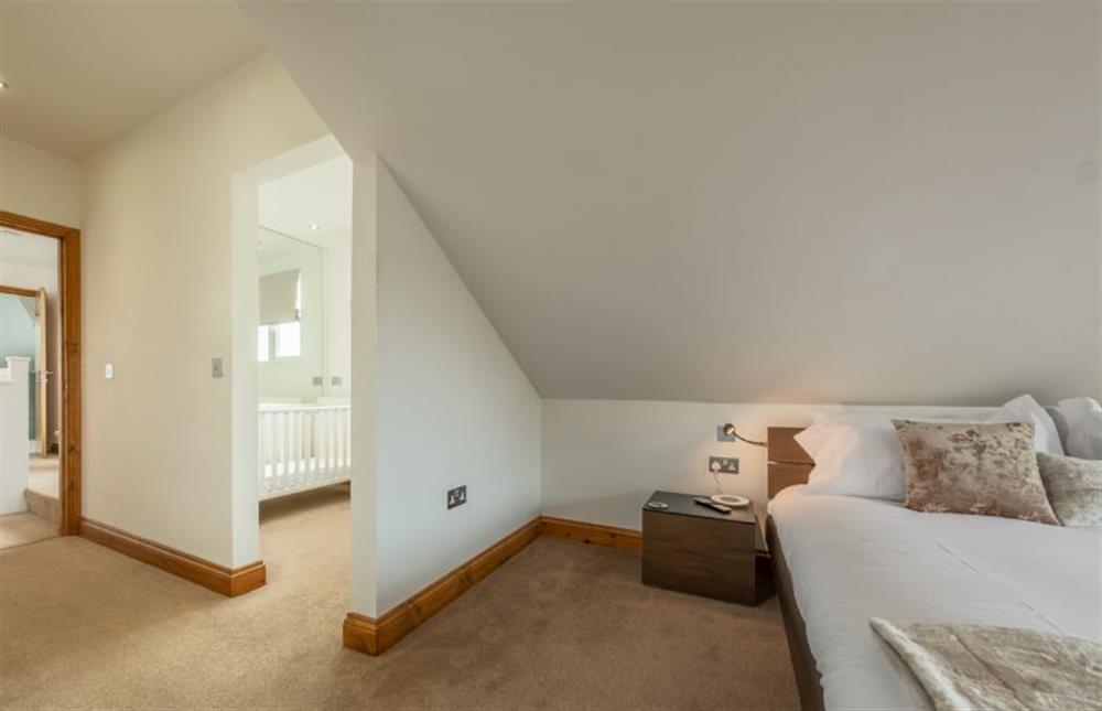 First floor: Master bedroom with adjoining nursery at Grace Cottage, Heacham near Kings Lynn