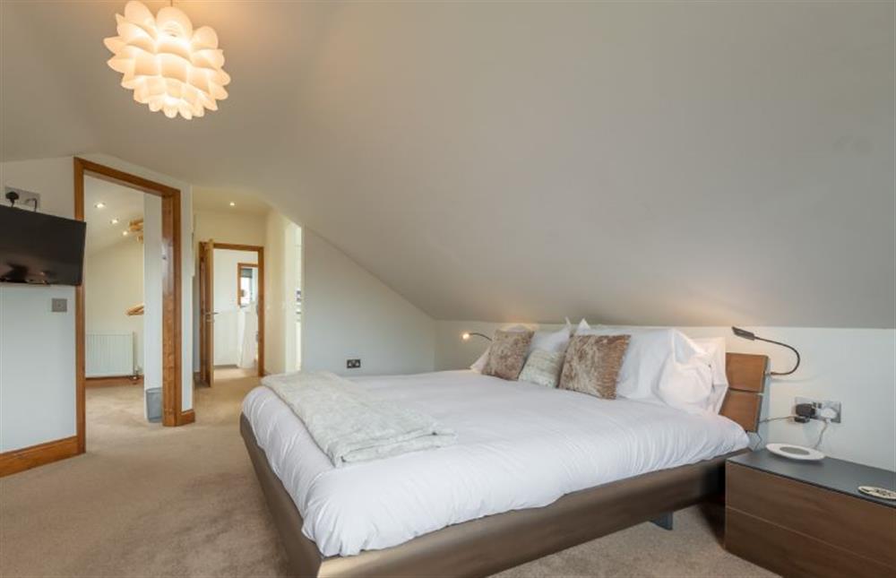 First floor: Master bedroom with super-king size bed and dressing room at Grace Cottage, Heacham near Kings Lynn