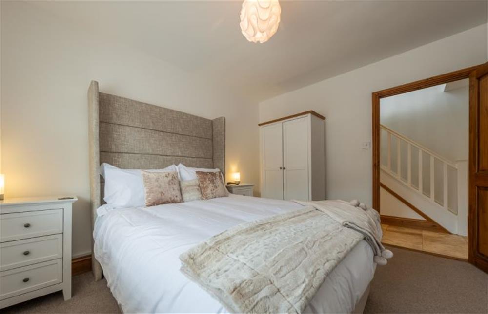 Ground floor: Bedroom four with king-size and oversized headboard at Grace Cottage, Heacham near Kings Lynn