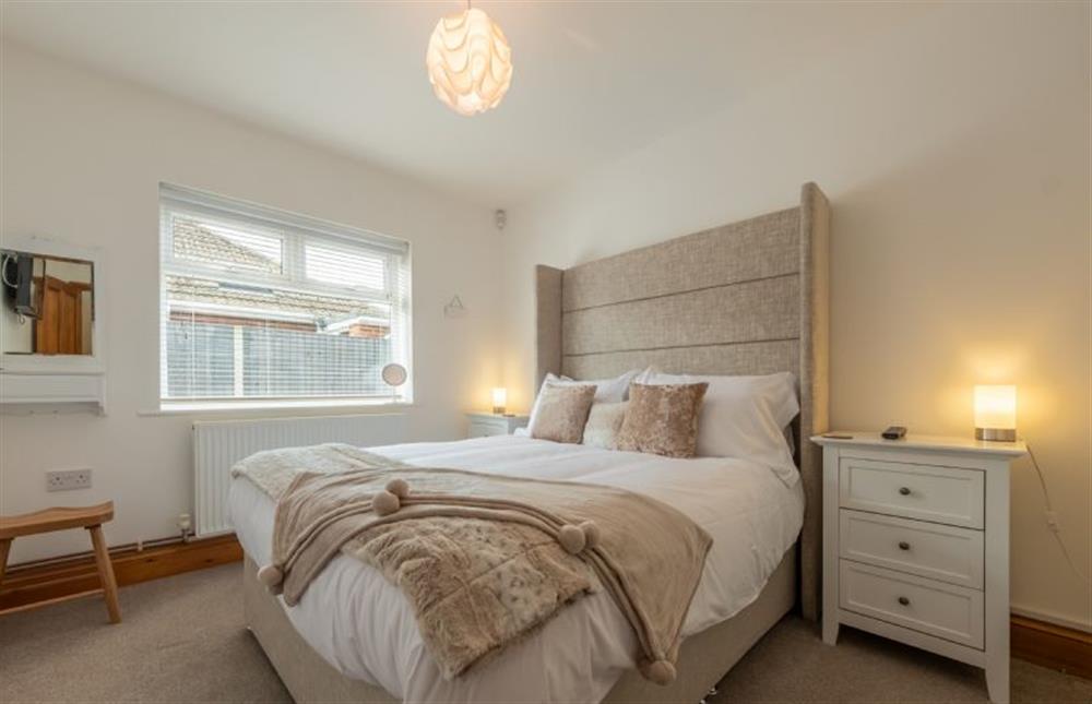 Ground floor: Bedroom four with king-size bed at Grace Cottage, Heacham near Kings Lynn