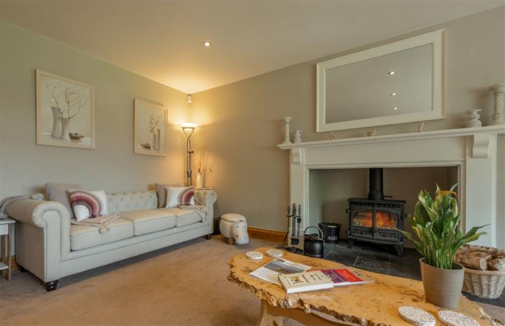 Ground floor: Comfy sitting room with wood burning stove at Grace Cottage, Heacham near Kings Lynn