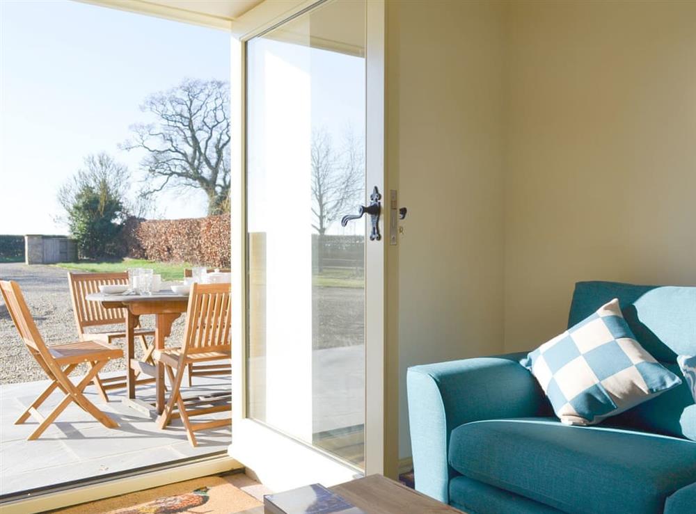 Snug with door opening on to patio at Grange Cottage in Harome, near Helmsley, North Yorkshire