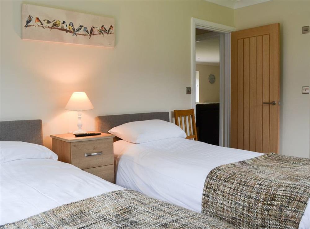 Pretty bedroom with twin single beds at Lucys at the Grange, 