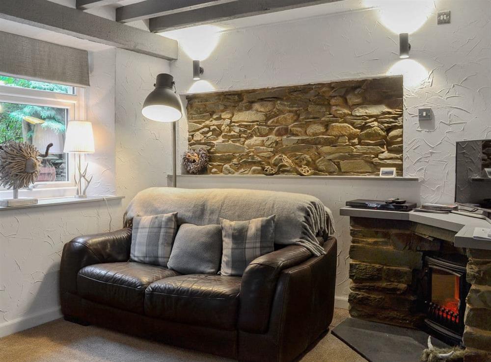 Characterful living area with exposed brickwork at Grange End Stables, 