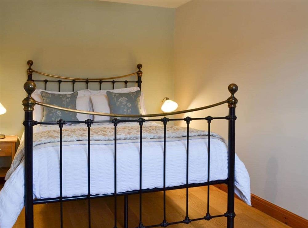 Romantic double bedroom with antique-style bed at The Wests, 