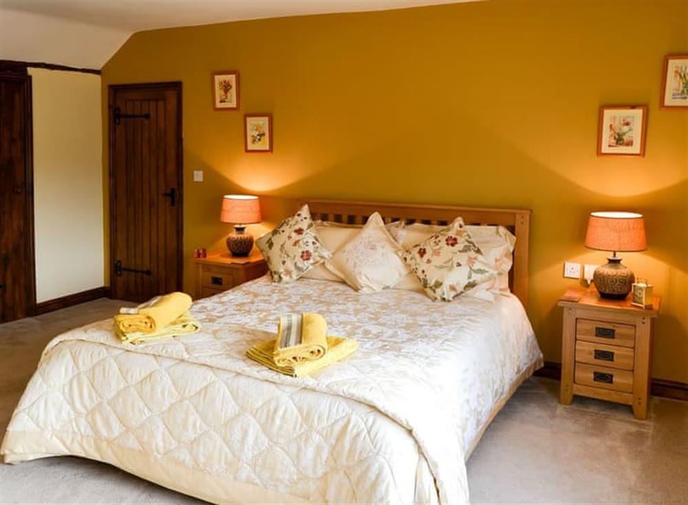 Comfortable bedroom with kingsize bed and en-suite at Grange Farmhouse in Hainford, near Aylsham, Norfolk