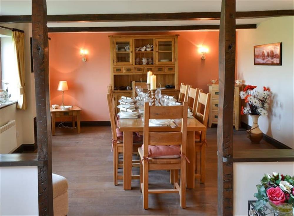 Dining room with beams and wooden floor at Grange Farmhouse in Hainford, near Aylsham, Norfolk