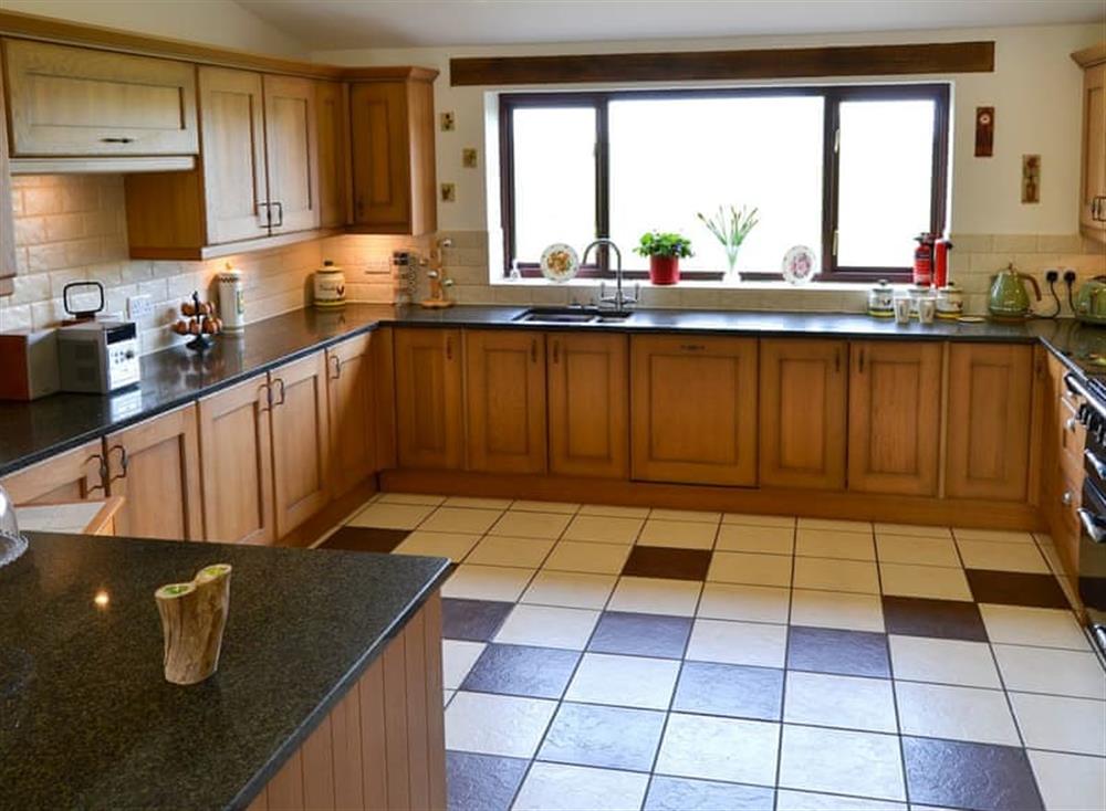 Farmhouse style kitchen with breakfast area at Grange Farmhouse in Hainford, near Aylsham, Norfolk