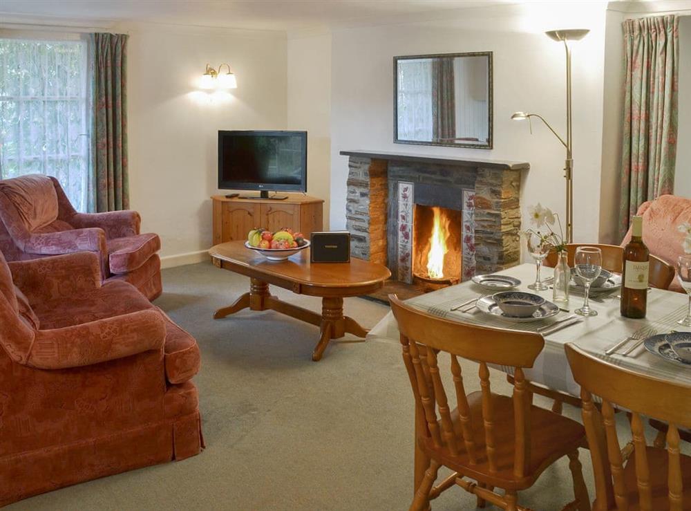 Living/ dining room with xosy open fire at Grannys Cottage in Lostwithiel, Cornwall