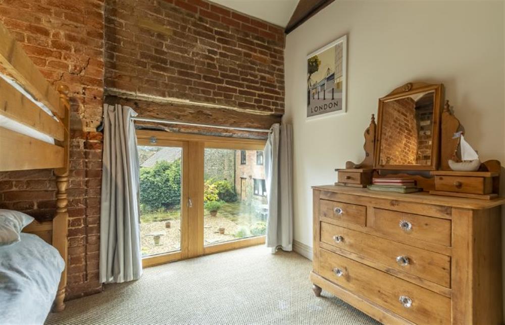 First floor: Bunk room has exposed brick and timbers at Great Barn, Toftrees near Fakenham