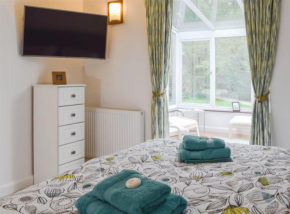 Comfortable double bedroom with conservatory at Greenacres Rest, 