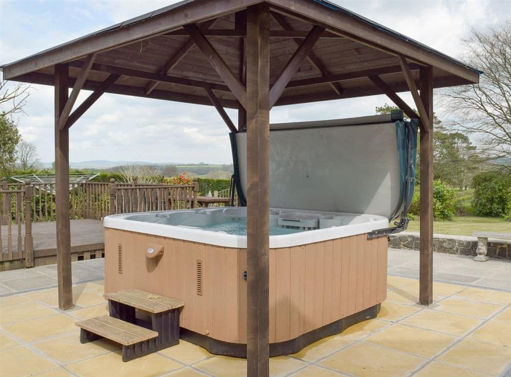 Shaded hot-tub on paved patio at Green Haven in Narberth, Pembrokeshire, Dyfed