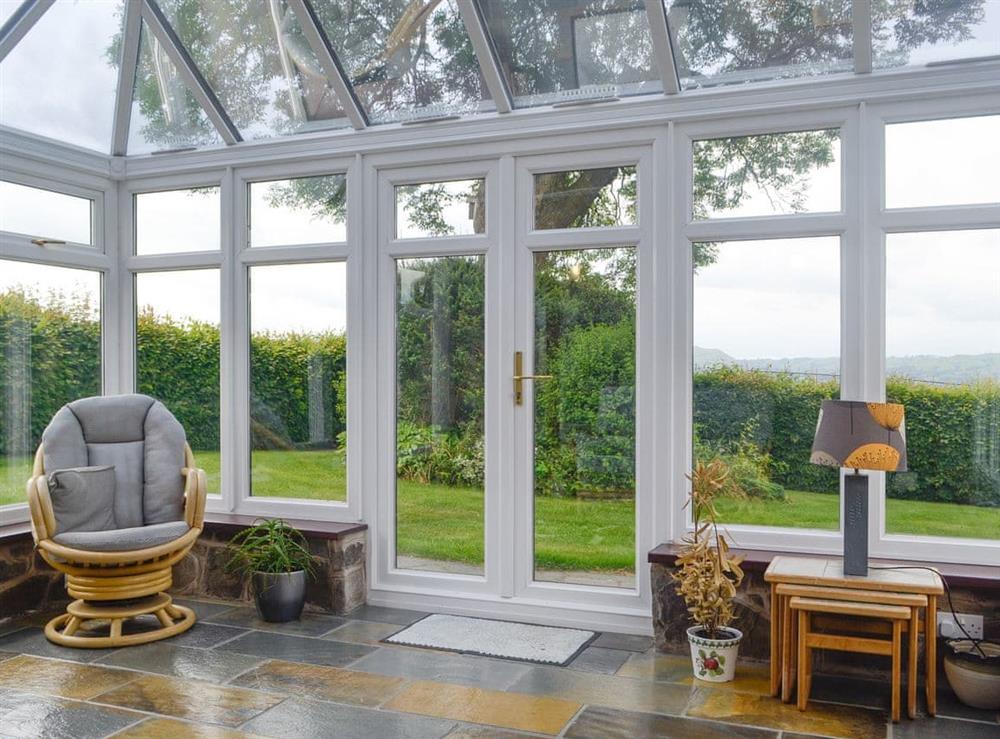 Spacious conservatory with access to garden at Green Lane Cottage in Aberhafesp, near Newtown, Powys