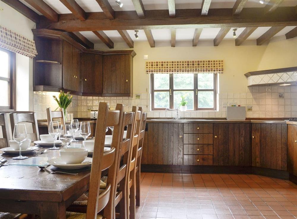 Well-equipped fitted kitchen with dining area at Green Lane Cottage in Aberhafesp, near Newtown, Powys