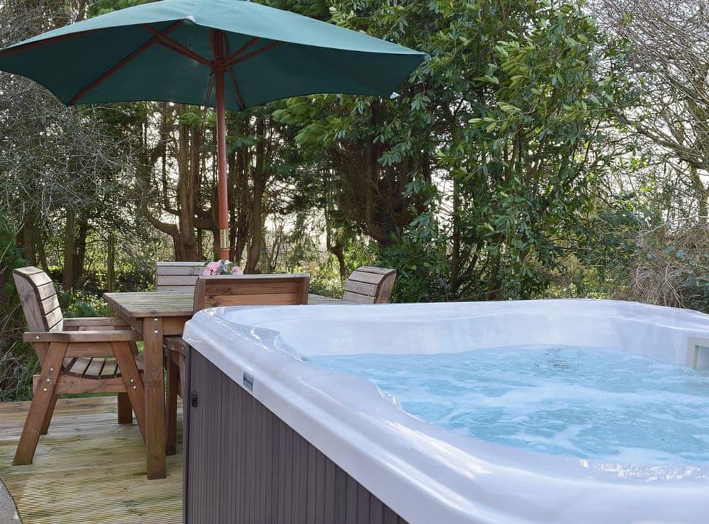 Secluded private hot tub and table and chairs at Greenacres in Reynalton, near Tenby, Pembrokeshire, Dyfed