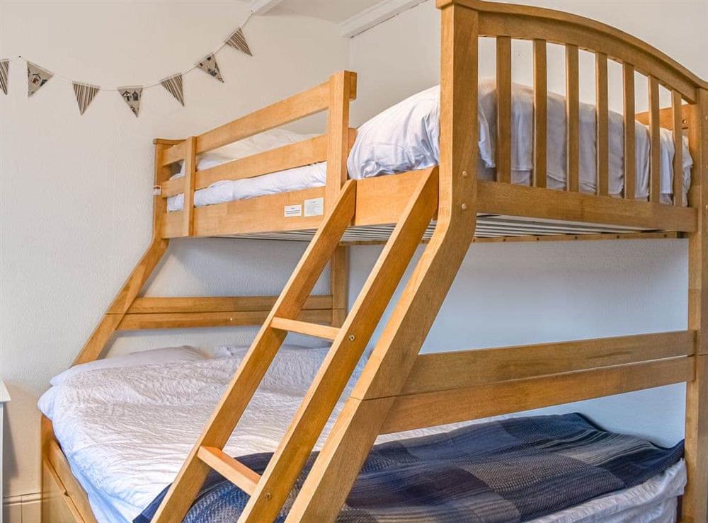 Triple bunk bedroom at Greenacres in Treburrick near Porthcothan Bay, Cornwall