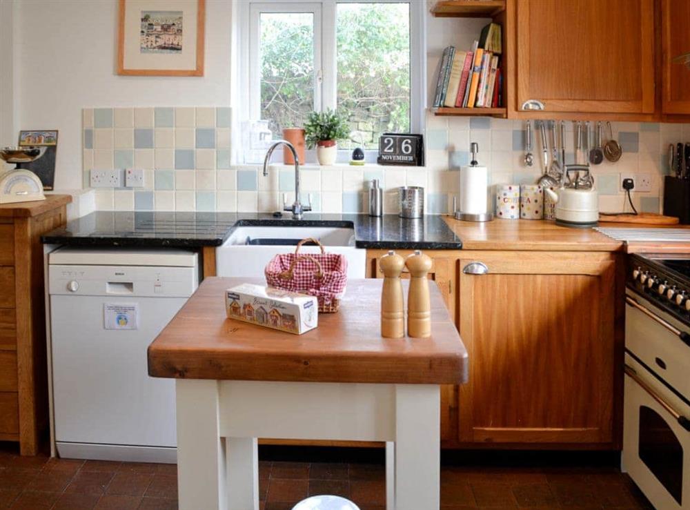 Kitchen with quarry tiles and island at Greenbanks in Chesil Beach, near Abbotsbury, Dorset