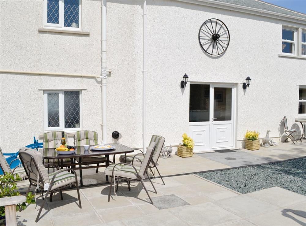 Paved patio area with outdoor furniture at Greengill Farm Barn in Greengill, near Wigton, Cumbria