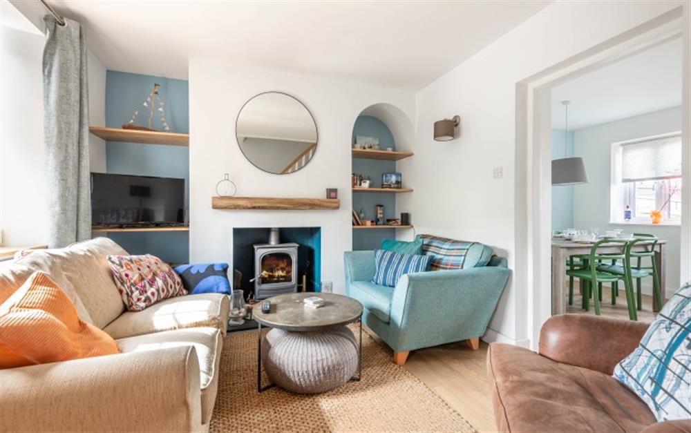 Cosy sitting room with log burner and smart TV at Greenhill Cottage in East Allington