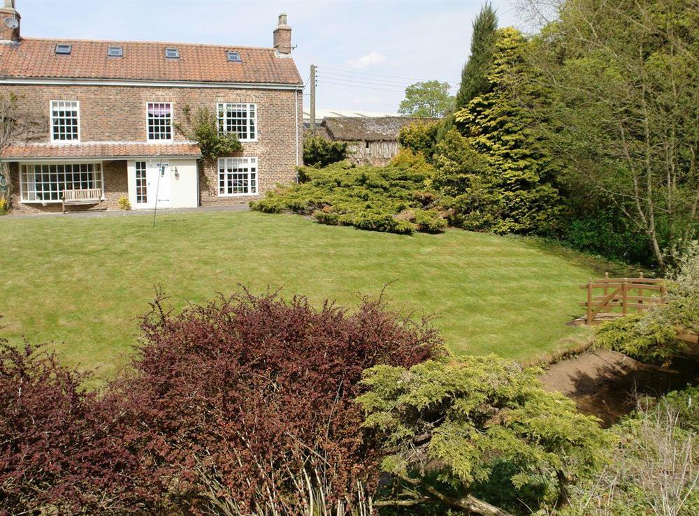 Mature front gardens at Greenlands Farmhouse in Barmby Moor, York., North Yorkshire