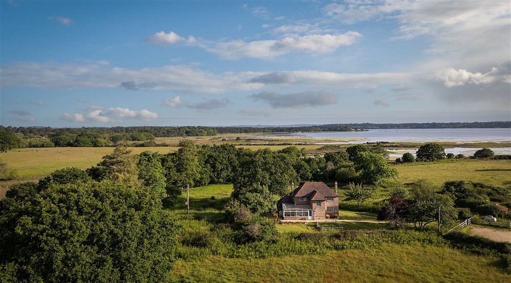 An aerial view of Greenlands, with Poole Harbour in the distance, Dorset