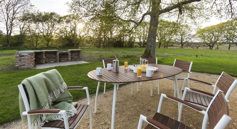 The garden area of Greenlands, Studland, Dorset with bbq, pizza oven and fire pit at Greenlands in Swanage, Dorset