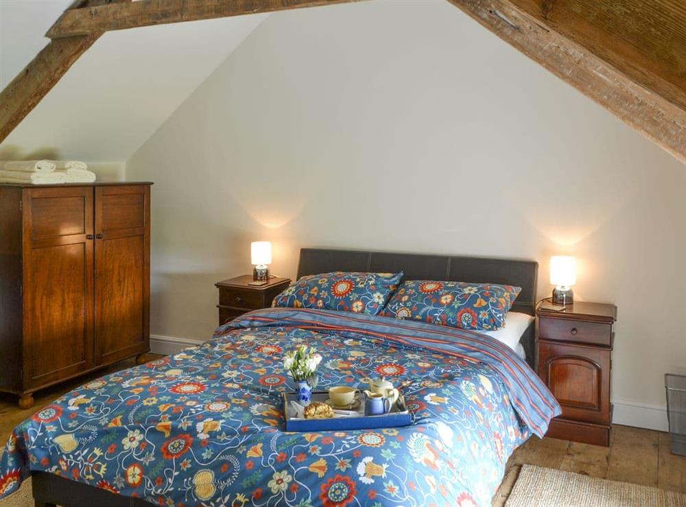 Relaxing double bedroom with exposed wood beams at Greenyard Cottage in Longhorsley, near Morpeth, Northumberland