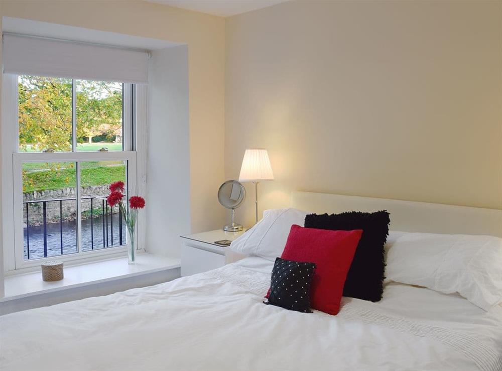 Cosy double bedroom with river view at Greta Side Court Apartments no 1 in Keswick, Cumbria