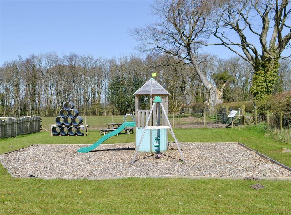 Children’s play area with lawned area and outdoor seating