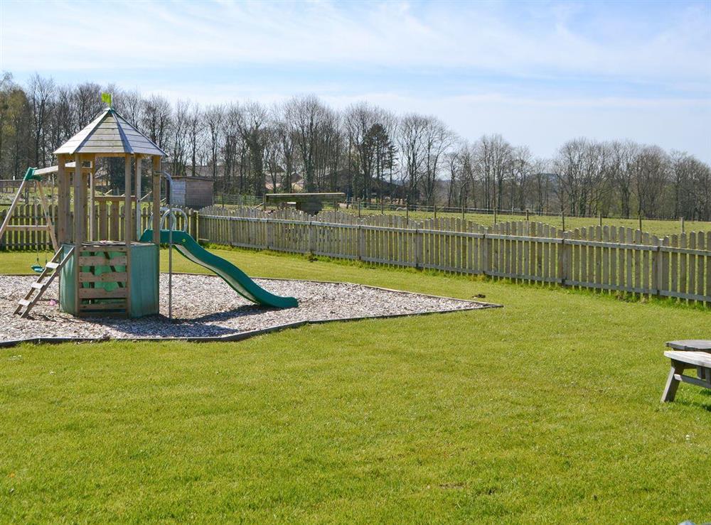 Children’s play area with lawned area and outdoor seating