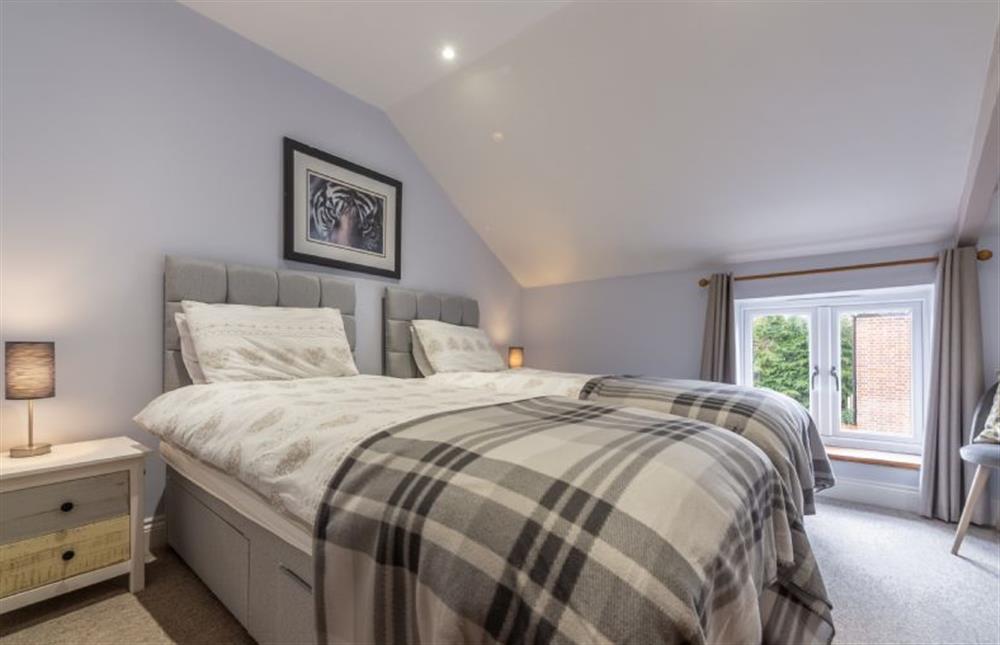 First floor: Bedroom two with zip-and-link bed twin option at Greyhound Cottage, Sculthorpe near Fakenham