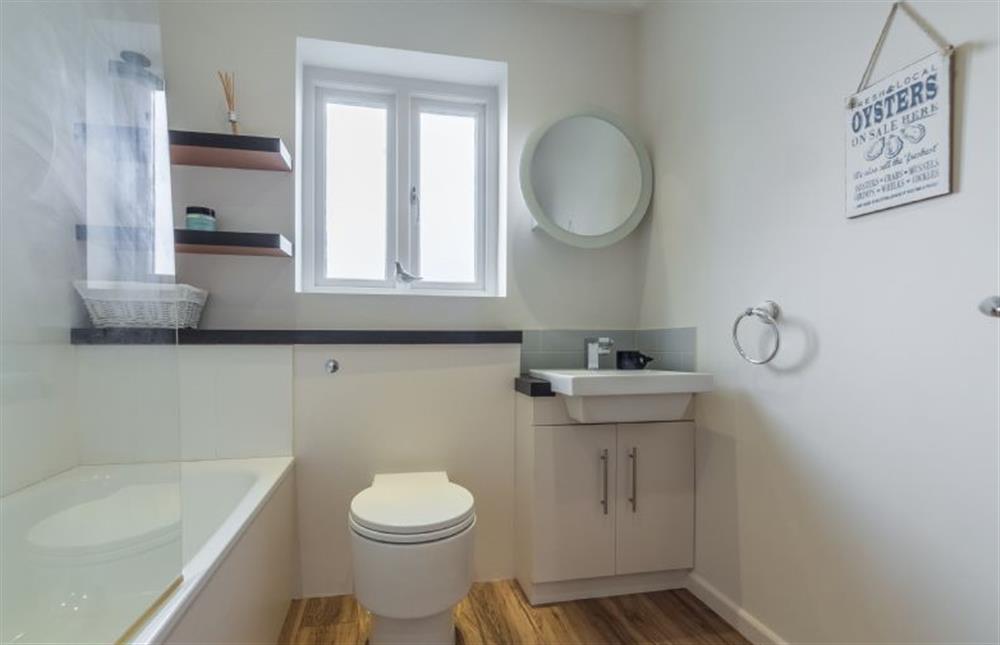 First floor: Bathroom with bath and WC at Greyseals, Brancaster near Kings Lynn
