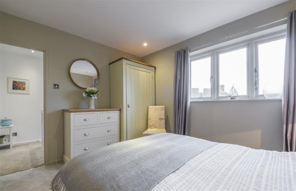 First floor: bedroom two with double bed and marsh views at Greyseals, Brancaster near Kings Lynn