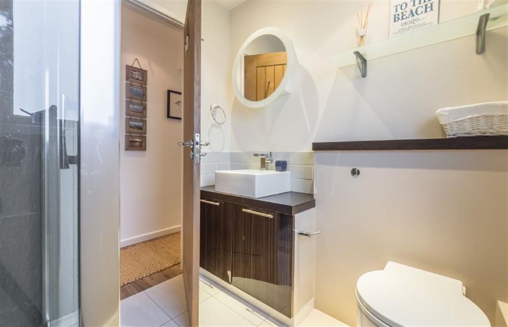 Ground floor: Shower room with WC and wash basin at Greyseals, Brancaster near Kings Lynn