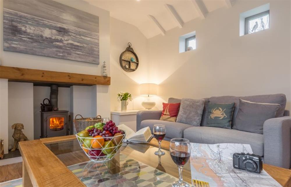 Ground floor: Sitting room with wood burning stove at Greyseals, Brancaster near Kings Lynn
