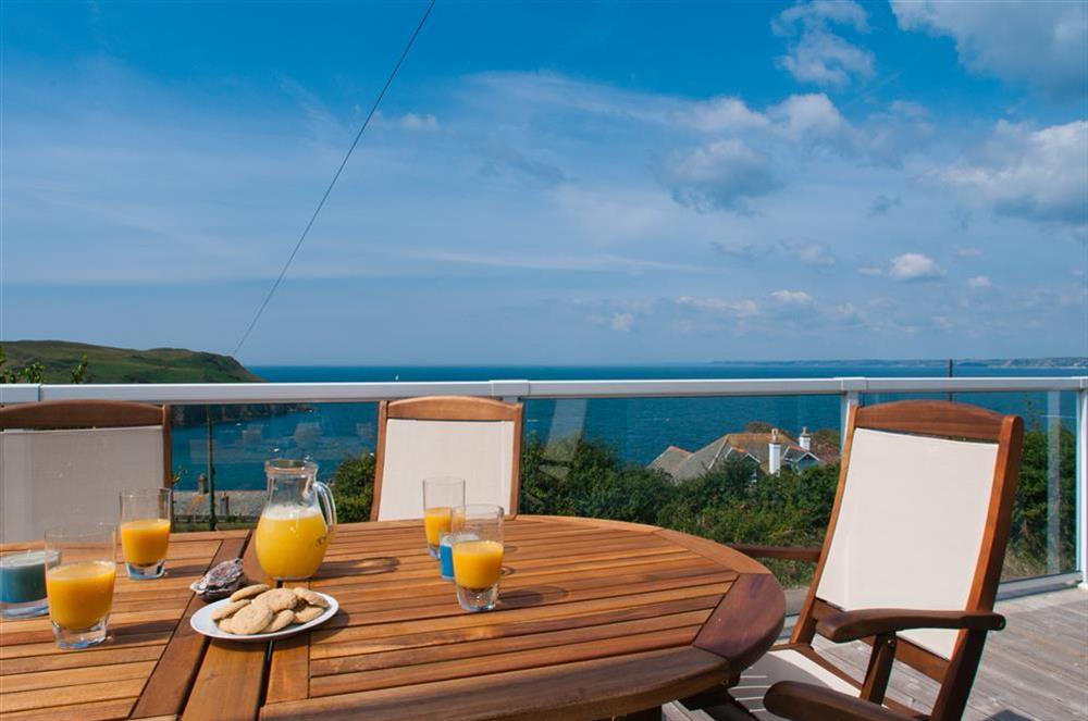 Balcony with table and eight chairs at Greystone in Hope Cove, Kingsbridge