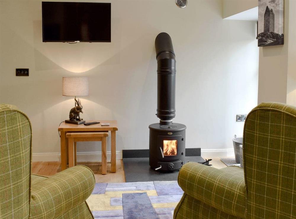 Delightful living room with wood burner at Grooms Bothy in Nenthorn, near Kelso, Roxburghshire