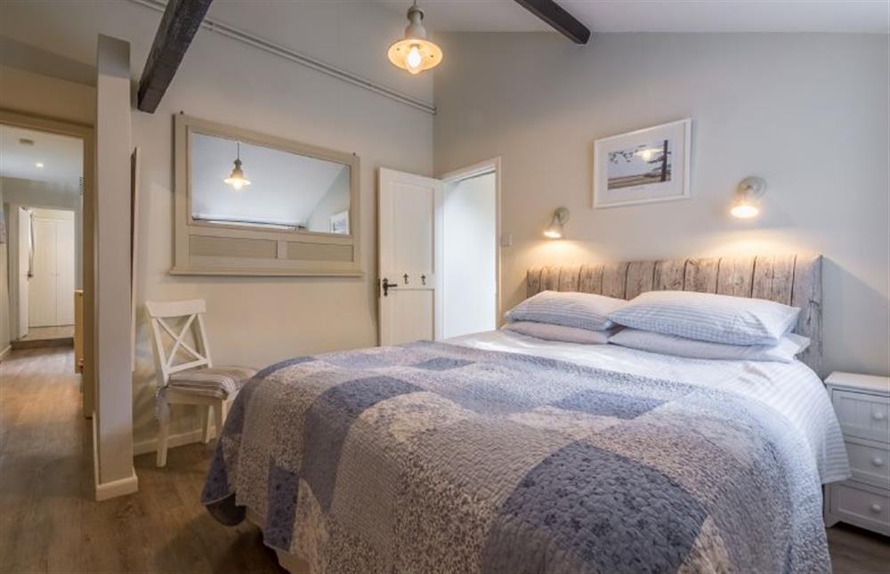 Ground floor: Master bedroom has King-size bed at Grooms Cottage (Brancaster), Brancaster near Kings Lynn