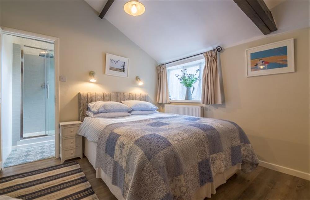 Ground floor: Master bedroom with en-suite shower room at Grooms Cottage (Brancaster), Brancaster near Kings Lynn