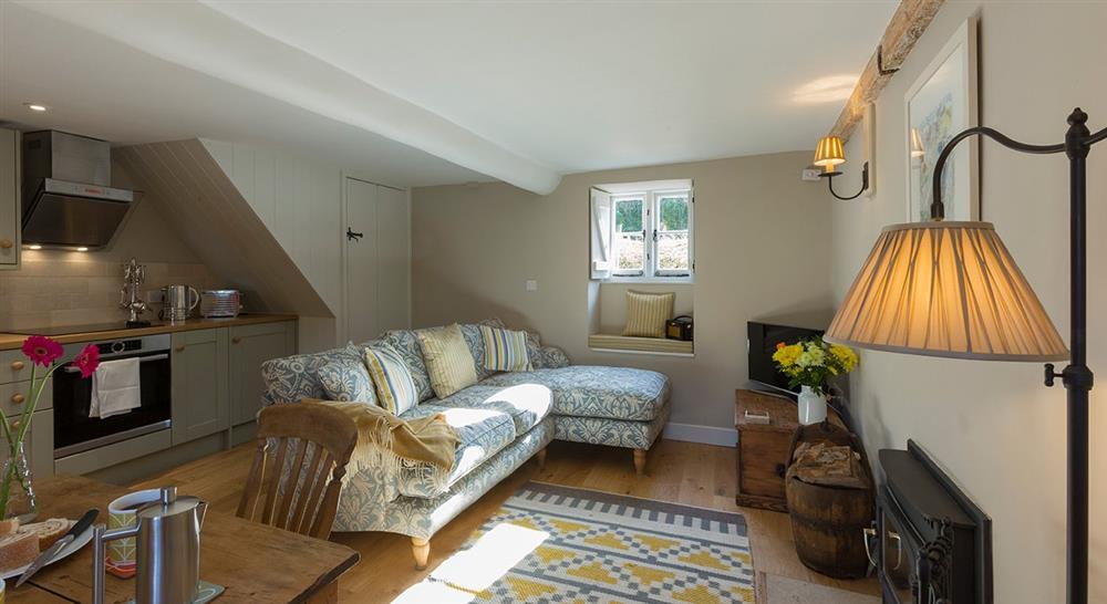 The open plan kitchen, dining and sitting room at Groom's Cottage in Corfe Castle, Dorset
