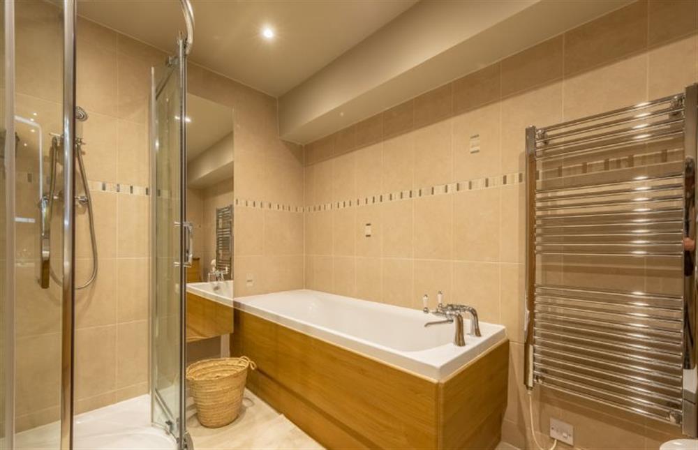 En-suite to bedroom one with a bath and separate shower at Gull Cottage, Holme-next-the-Sea