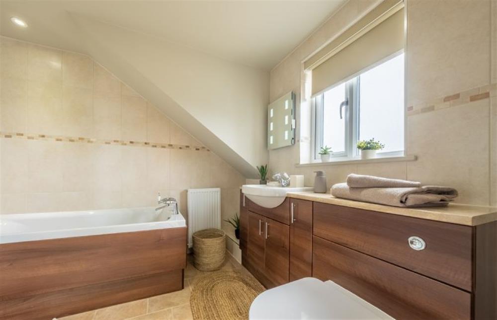 En-suite to bedroom two with a bath and separate shower at Gull Cottage, Holme-next-the-Sea