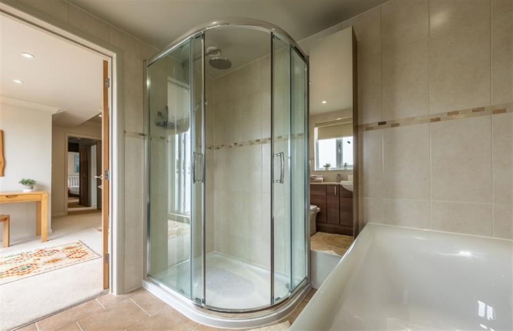 En-suite to bedroom with shower and bath at Gull Cottage, Holme-next-the-Sea