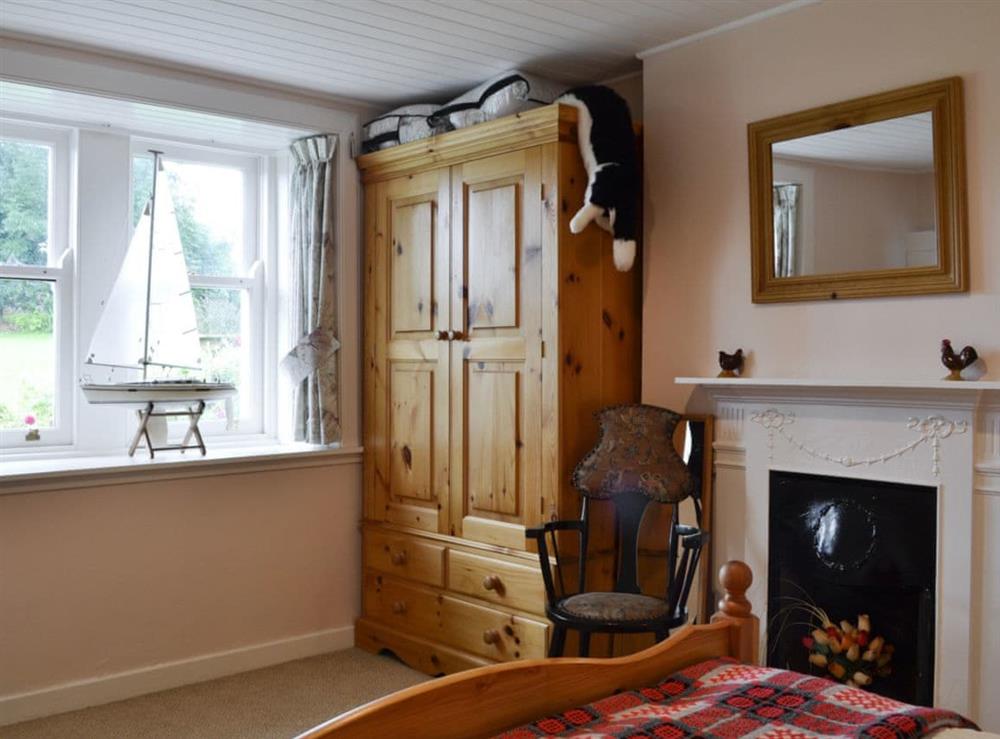 Tastefully furnished bedroom with scenic views at Gullieside Cottage in Kirkandrews, near Kirkcudbright, Kirkcudbrightshire