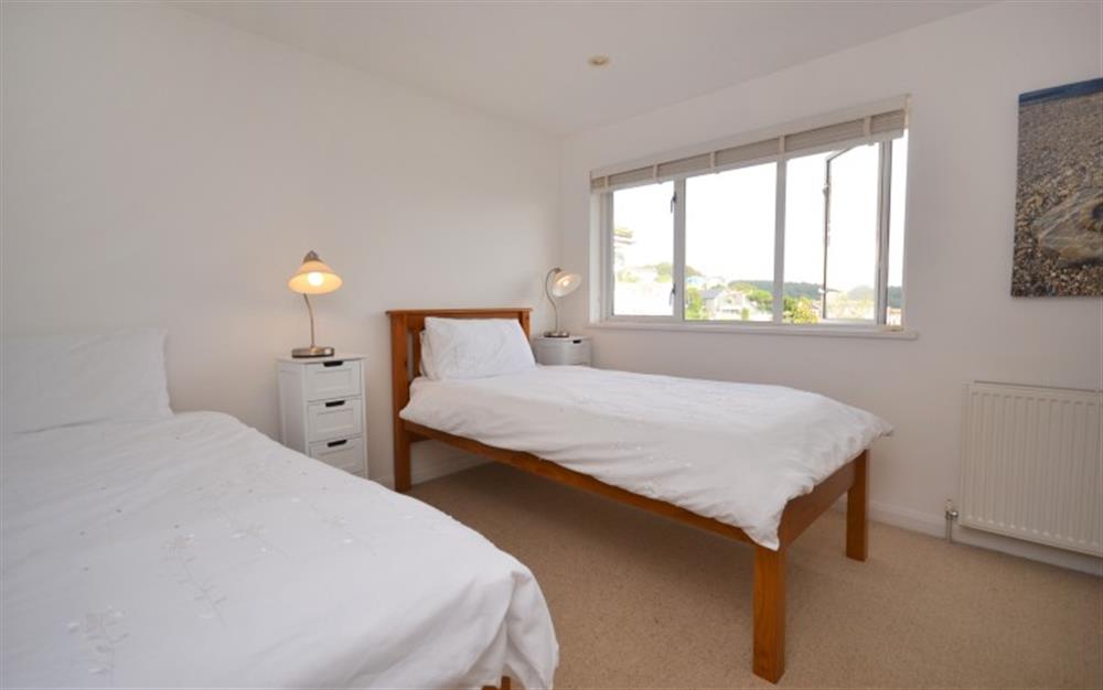 Bedroom 2 with single bed and single truckle bed and en suite shower room at Gulls Nest in Salcombe