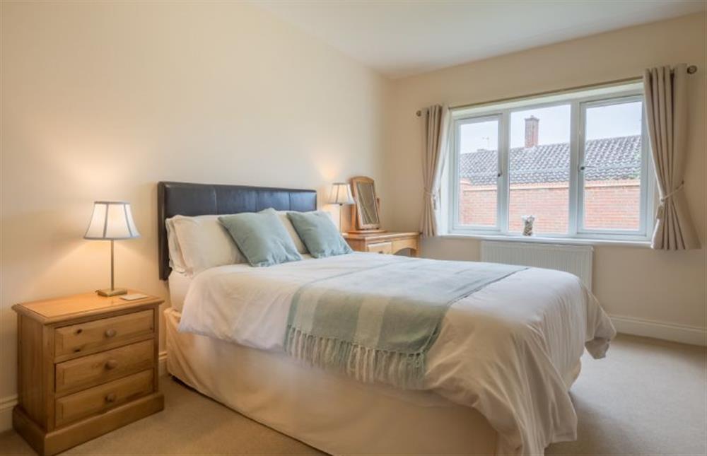 Ground floor: Master bedroom has a king-size bed at Gulls Nest, Wells-next-the-Sea